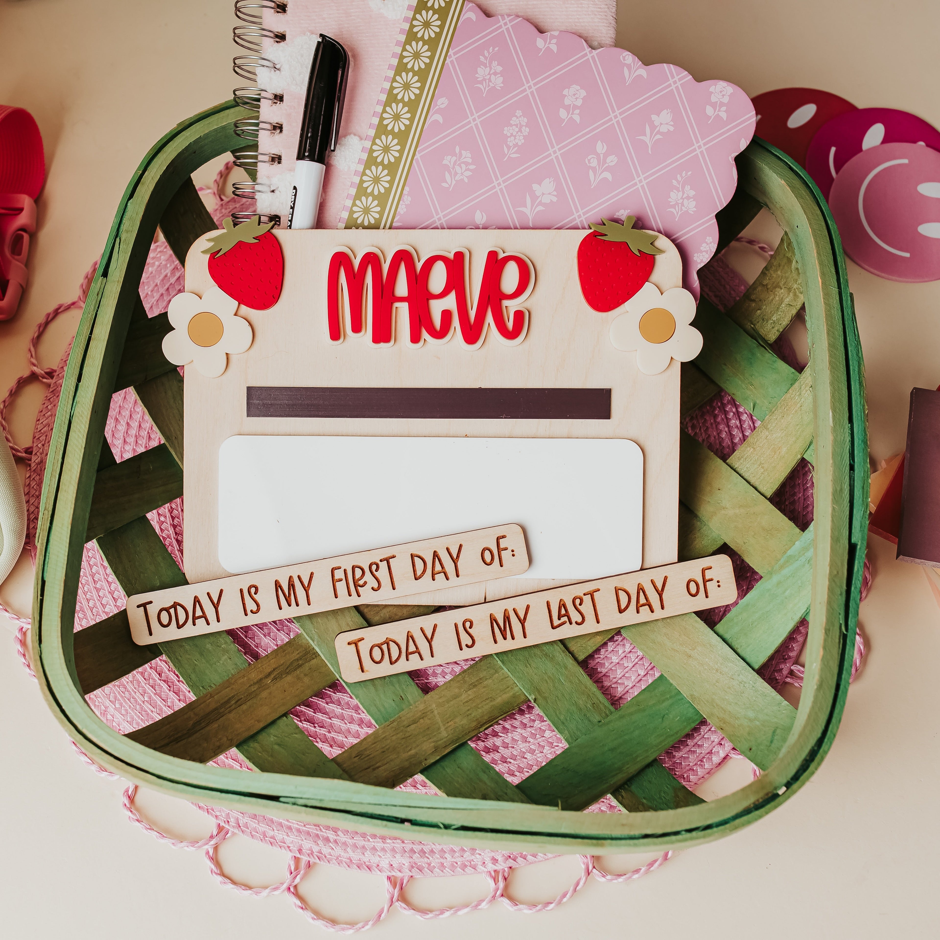 A woven green basket, featuring a central back to school sign that reads 'Maeve'.