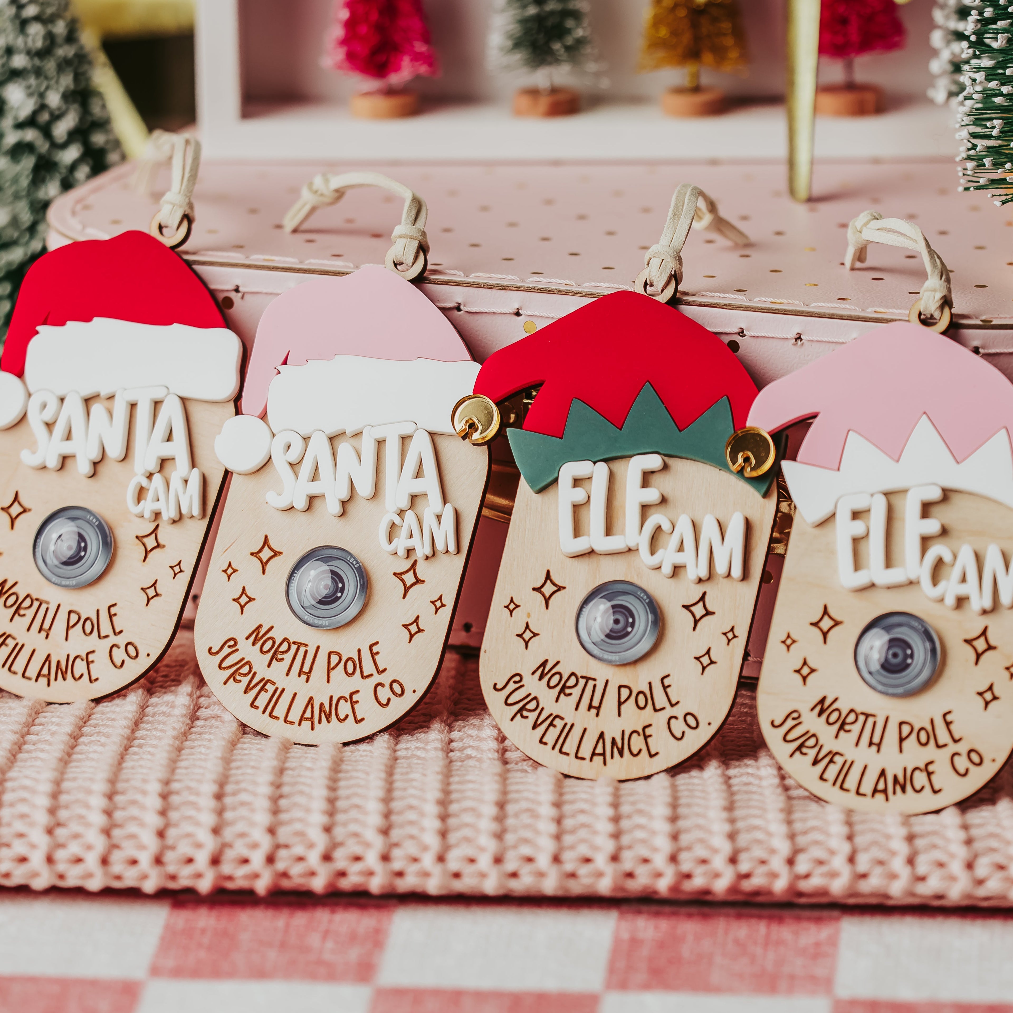 Four Christmas-themed faux camera tags Santa and Elf hats that read 'SANTA CAM', 'ELF CAM' and north pole surveillance 